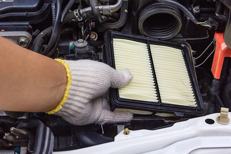 Mechanic Replacing An Air Filter
