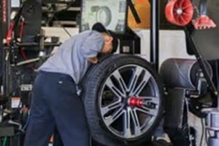 Service technician working on a tire rotation service