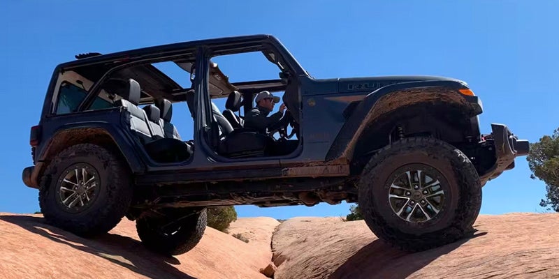 right hand view of a 2024 jeep wrangler driving in a desert