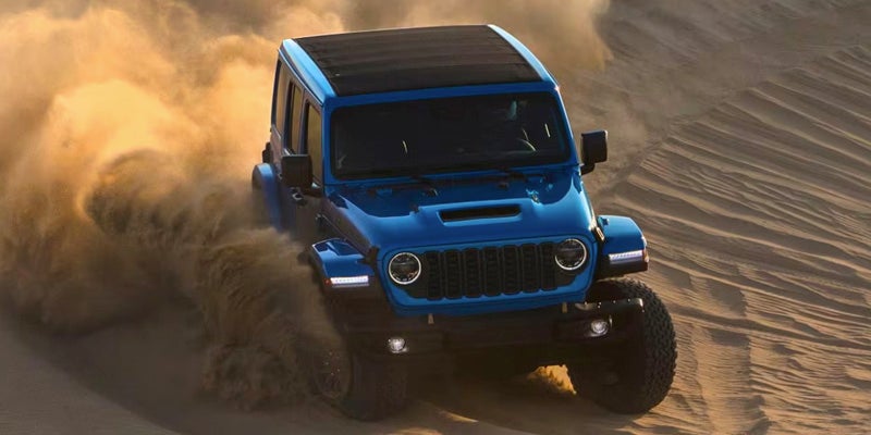 a 2024 jeep wrangler going down a sand dune